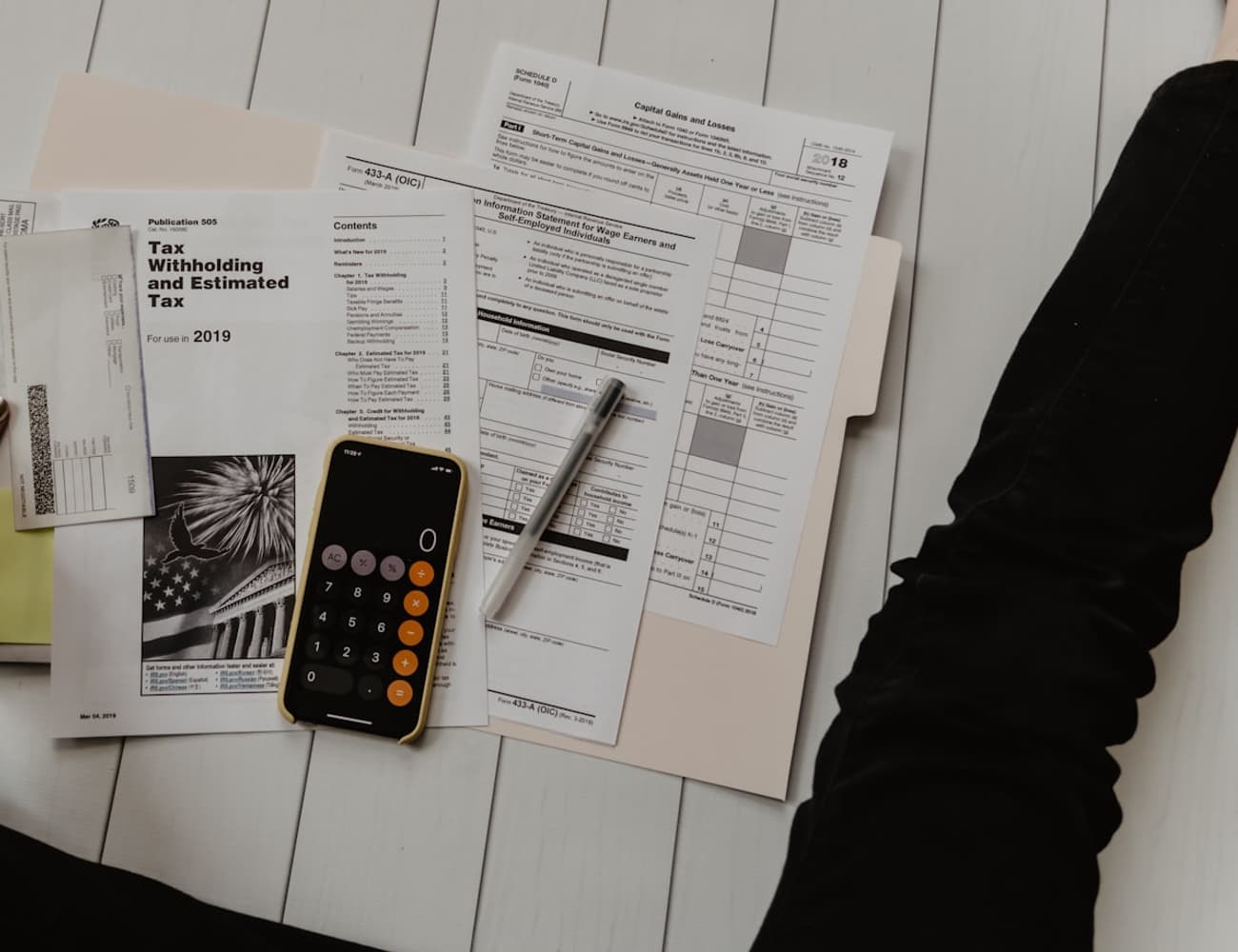 A lab report being reviewed alongside a phone